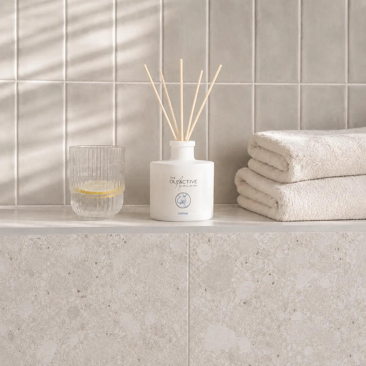 Raumdiffuser Cotton von The Olfactive Avenue — im hellen Bad mit Handtüchern und Glas