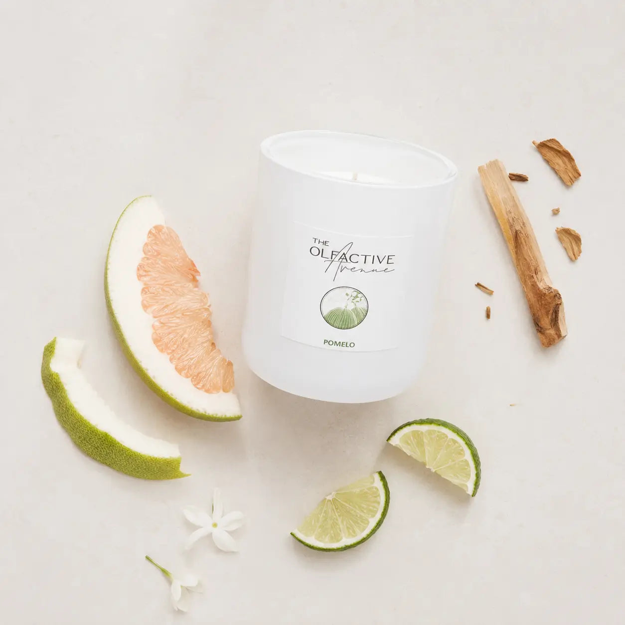 Duftkerze Pomelo von The Olfactive Avenue — Flatlay mit Pomelo, Limette und Holznoten